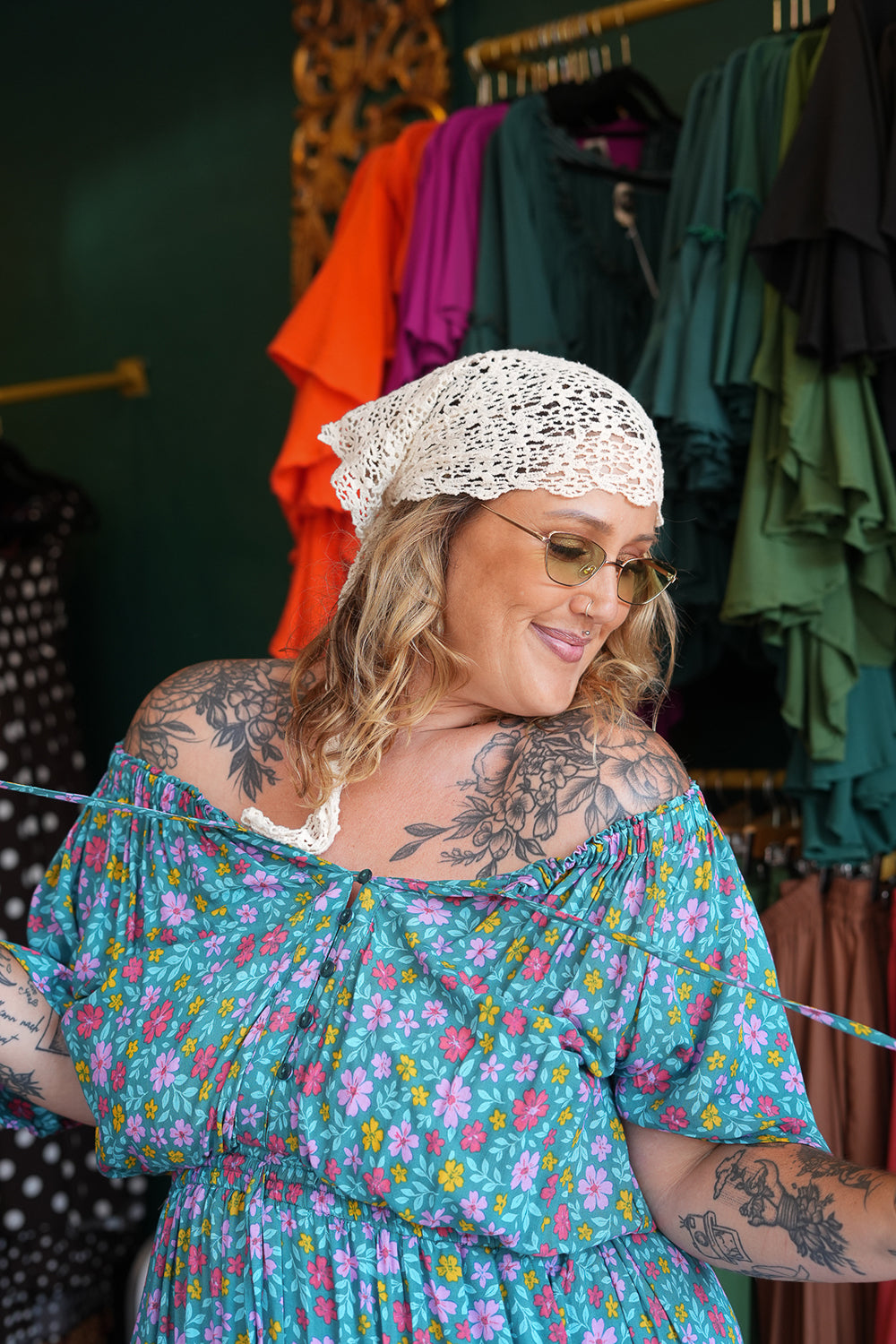 Meet the Dainty Dress in Aqua Bloom, a flowing rayon maxi with an adjustable off-shoulder neckline, elastic waist, tiered skirt and pockets. Handmade in Bali.