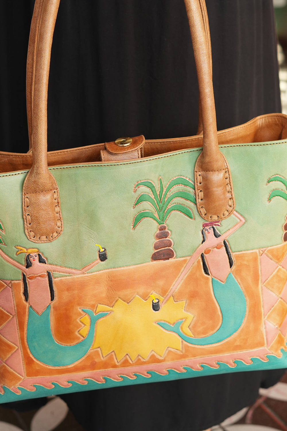Meet the Desert Siren Tote in Sage and Caramel. A handcrafted leather tote with hand tooled motives artwork, long handles and practical interior compartments.