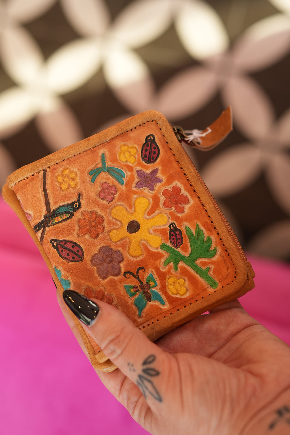 Meet the Freebird Mini Wallet in Desert Honey, a handcrafted leather wallet with colorful flowers, hummingbirds, ladybirds and butterfly artwork.