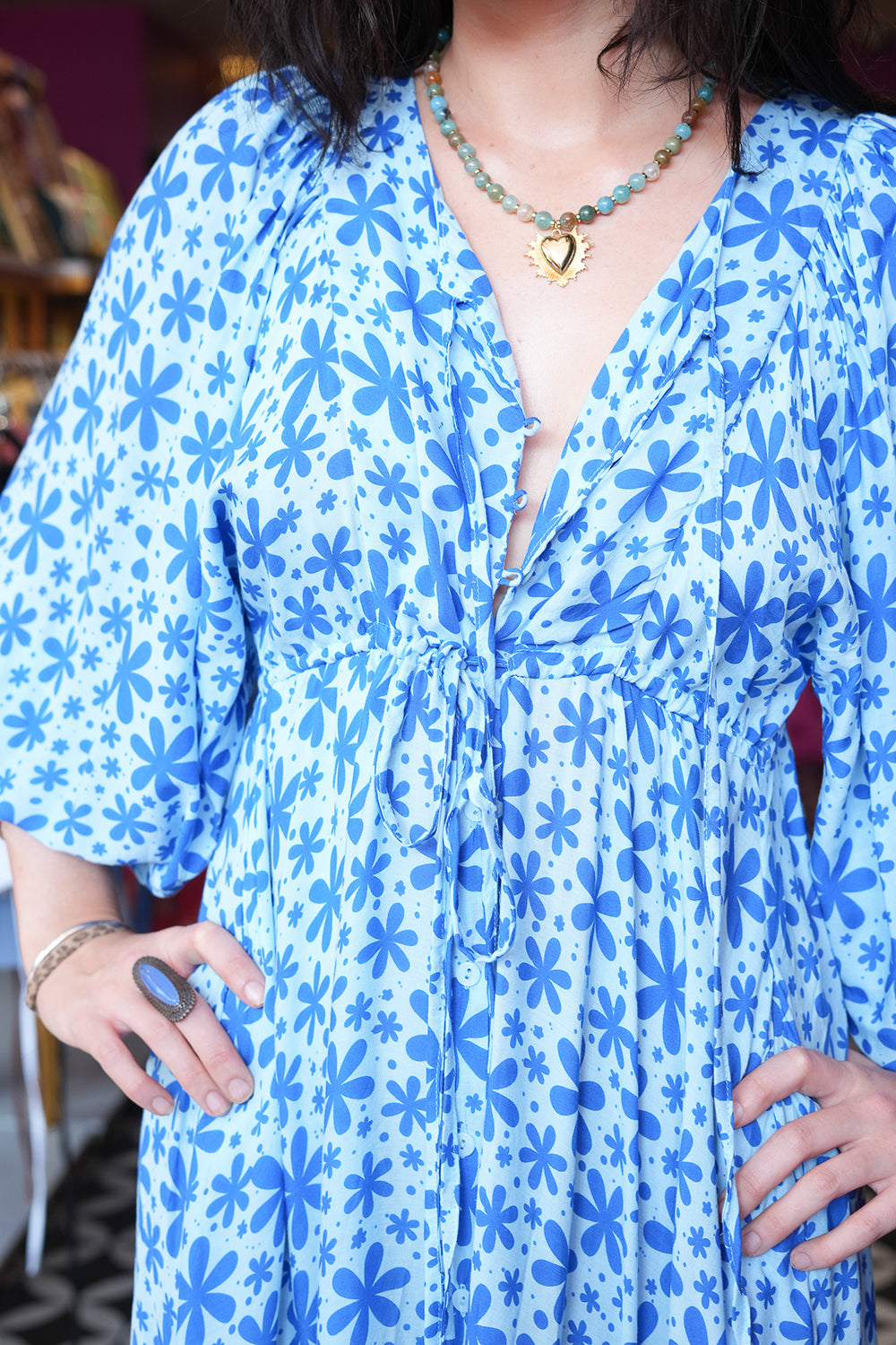 Meet the Magnolia Dress in Floral Blue, a flowing floral boho maxi with billowy sleeves, shell buttons, adjustable waist tie and pockets. Handmade in Bali.