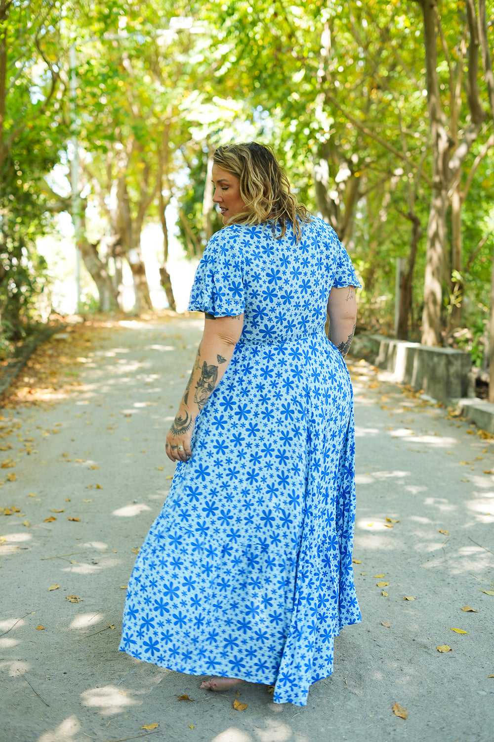 Shop the Mary Maxi Dress in Blue Floral Magic, with butterfly sleeves, deep V-neck and a flowing full-circle skirt. Handmade in Bali by Jinx the Label.