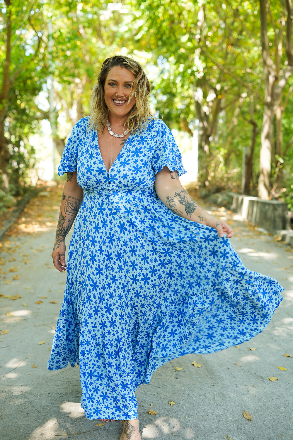 Shop the Mary Maxi Dress in Blue Floral Magic, with butterfly sleeves, deep V-neck and a flowing full-circle skirt. Handmade in Bali by Jinx the Label.
