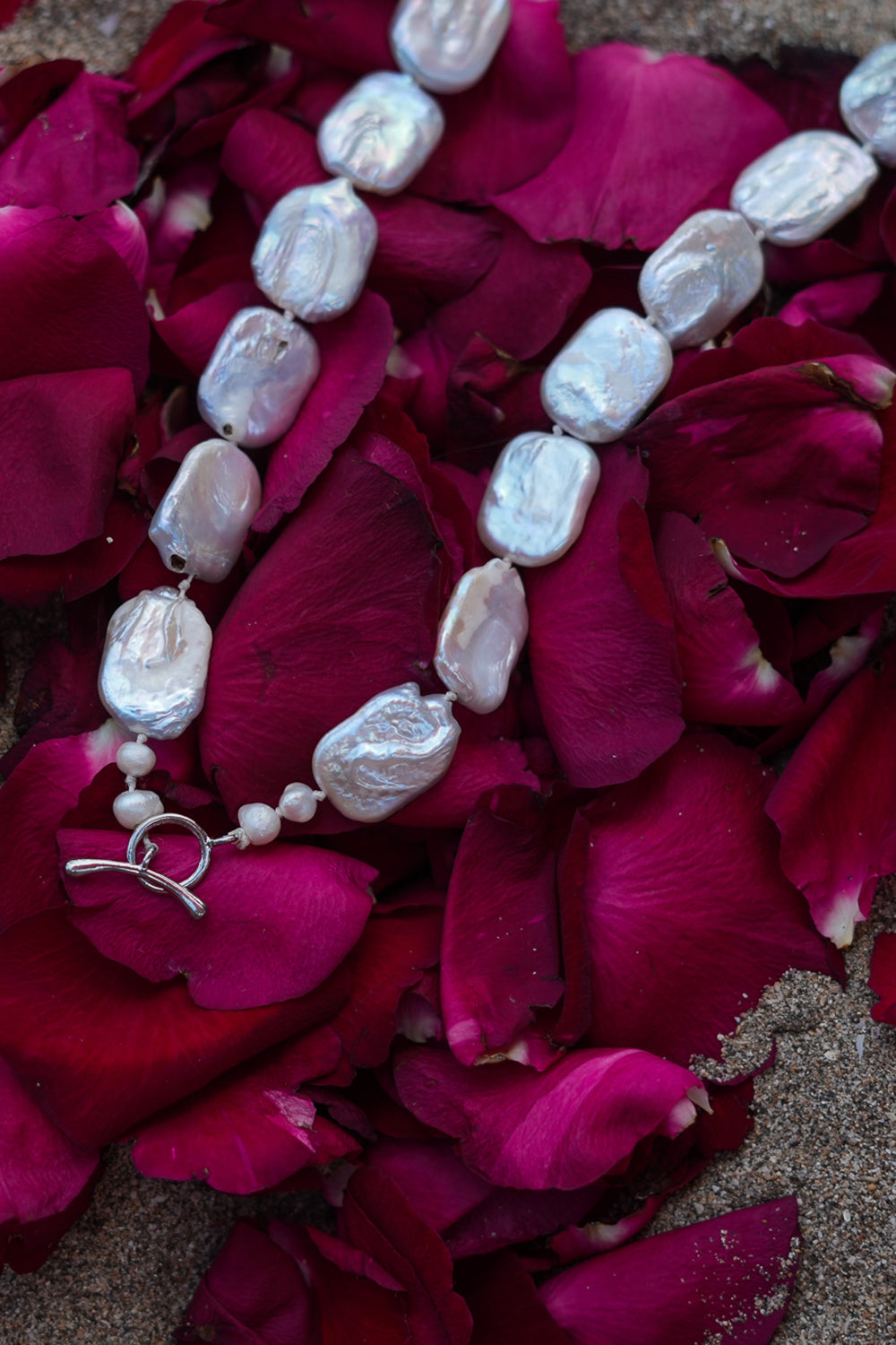 Discover the Moon Tide Necklace in Lunar Pearl, with irregular natural pearls and a gold toned toggle closure from Earth Altering by Jinx the Label.