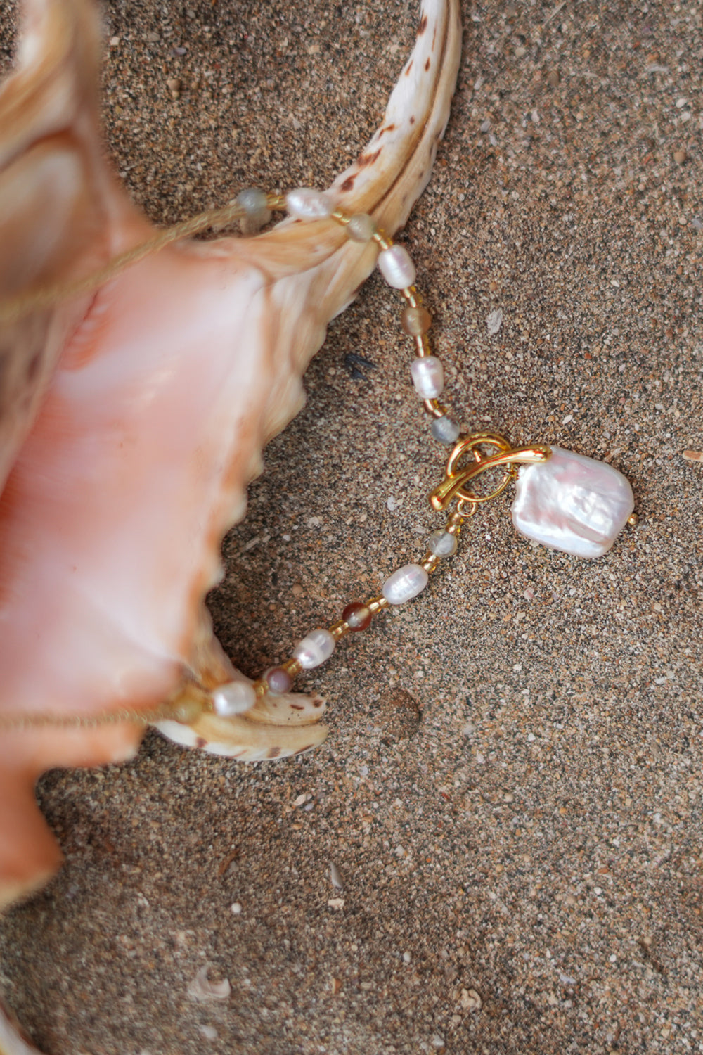 Shop the Moonwater Necklace in Pearl Gold, with delicate beads, organic pearls, gold toggle and a baroque pearl pendant from Earth Altering by Jinx the Label.