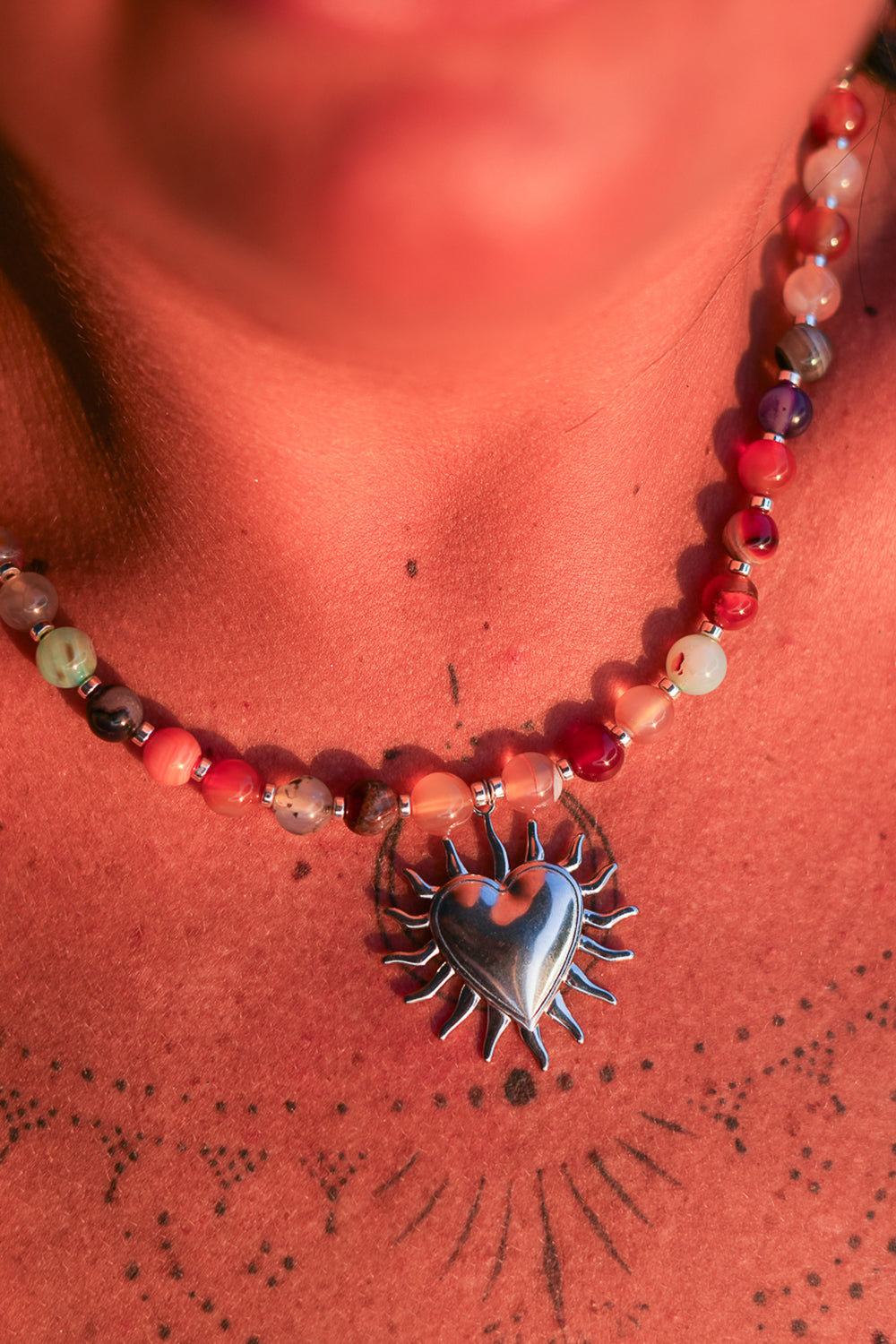 Meet the Sacred Flame Necklace in Wild Ember, with colorful natural stone beads and a statement silver heart pendant from Earth Altering by Jinx the Label.