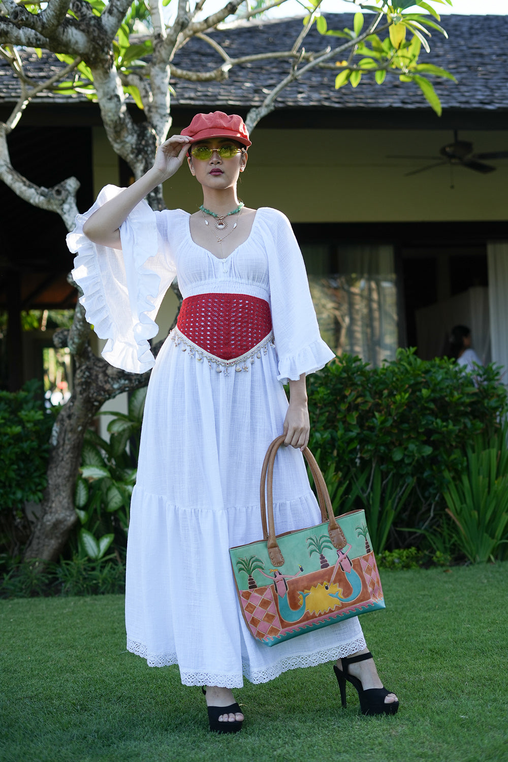 Meet the Tina Maxi Dress in White from Nevada. A dreamy cotton maxi with statement bell sleeves, shirred waist, button detailing and a lace trimmed hem.