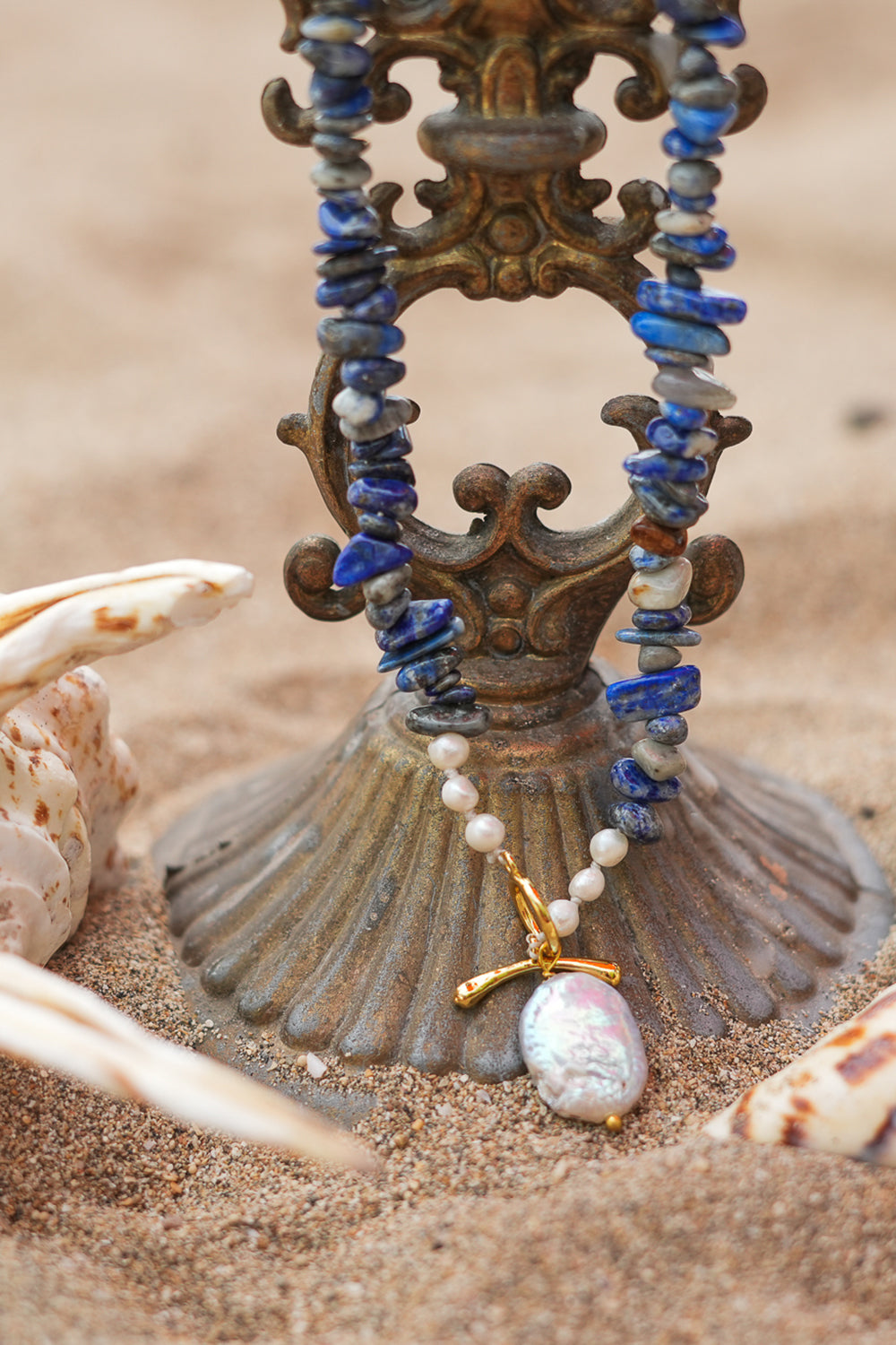 Discover the Wild Earth Necklace in Lapis Lazuli, featuring deep blue natural stones, freshwater pearls and a statement baroque pearl pendant by Jinx the Label.