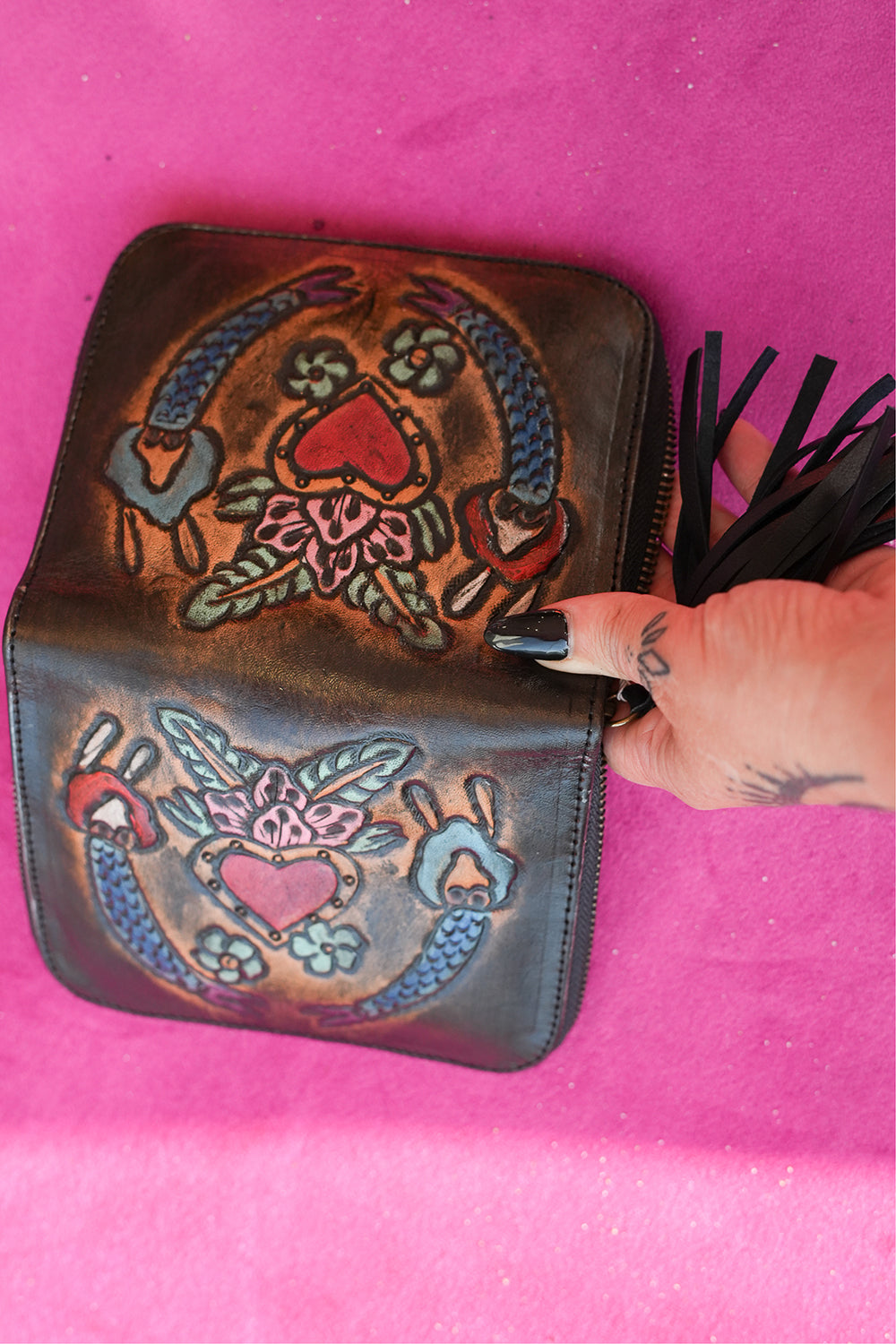 Meet the Wildheart Wallet in Burnished Espresso. A handcrafted leather zip wallet with hand tooled motives, card slots, a coin compartment and leather tassel.