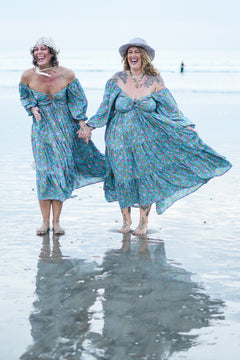 Meet the Amazonian Maxi Dress in Aqua Bloom, a flowing rayon floral maxi with an off-shoulder neckline, keyhole bodice, balloon sleeves and sweeping tiers.