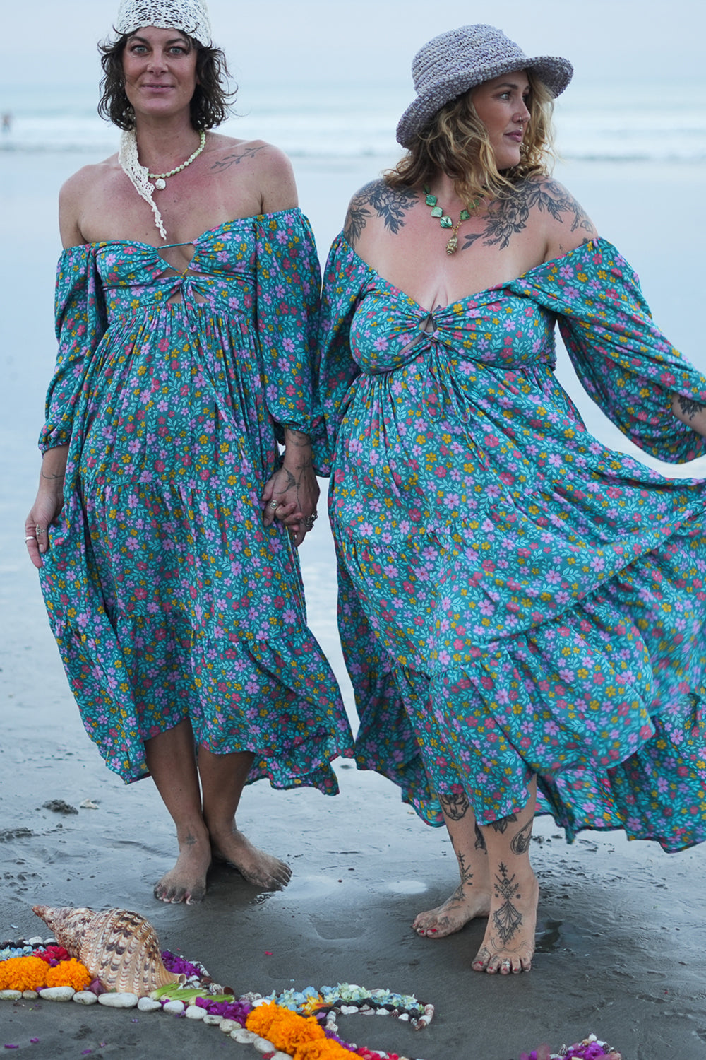 Meet the Amazonian Maxi Dress in Aqua Bloom, a flowing rayon floral maxi with an off-shoulder neckline, keyhole bodice, balloon sleeves and sweeping tiers.