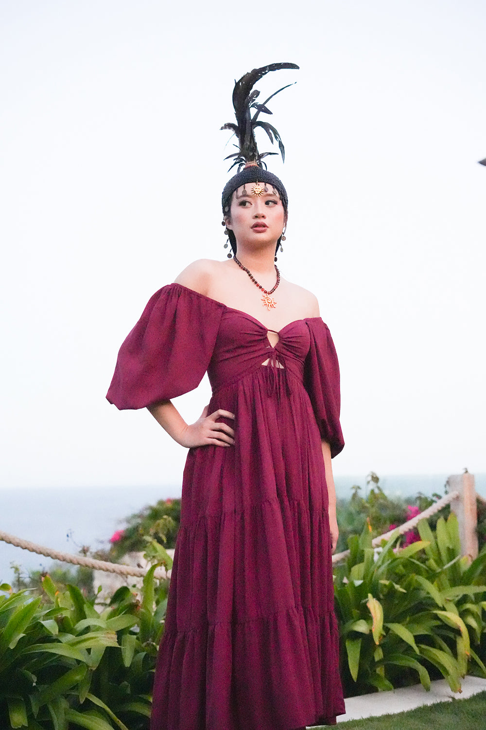Meet the Amazonian Maxi Dress in Maroon, a flowing rayon maxi with an off shoulder neckline, keyhole bodice, balloon sleeves and sweeping tiers.