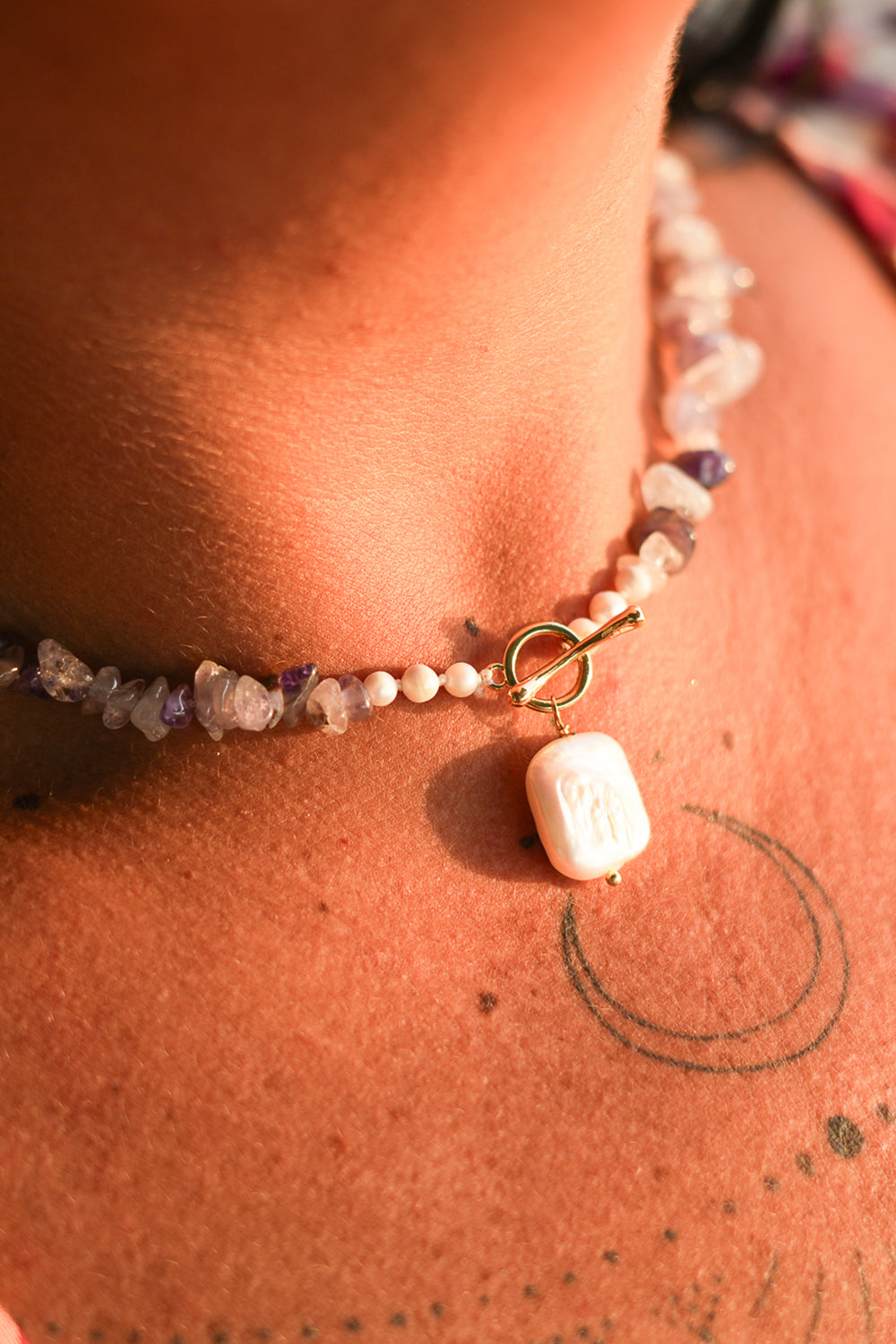 Shop the Amethyst Moon Necklace in Amethyst, with organic stone chips, petite pearls, gold toggle and a baroque pearl pendant by Jinx the Label.