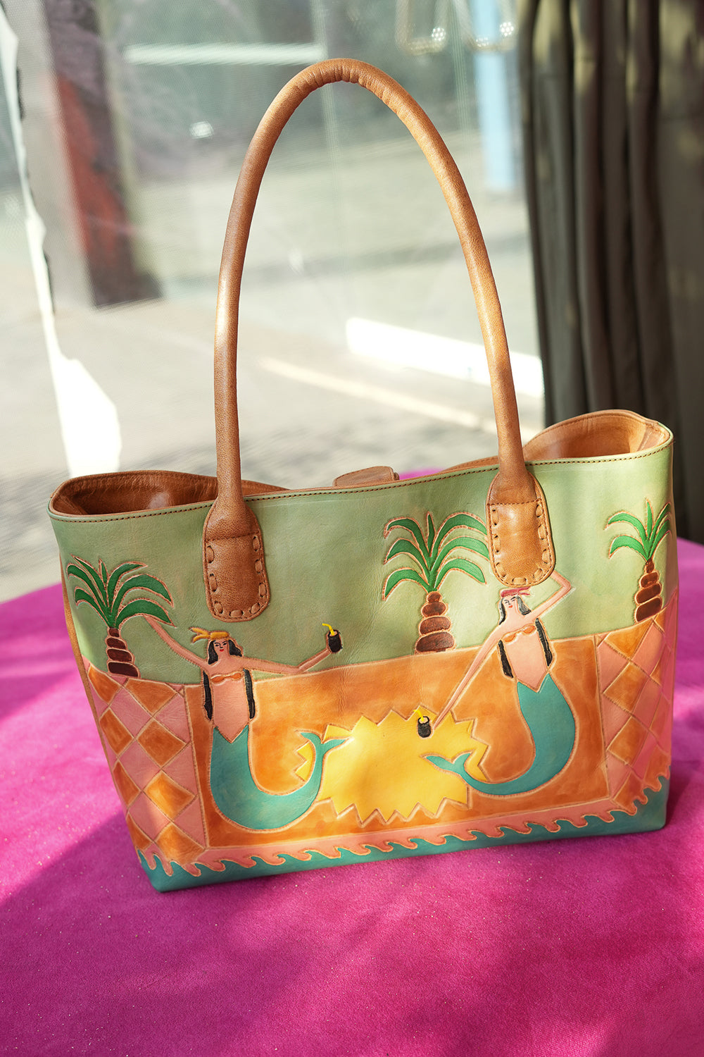 Meet the Desert Siren Tote in Sage and Caramel. A handcrafted leather tote with hand tooled motives artwork, long handles and practical interior compartments.