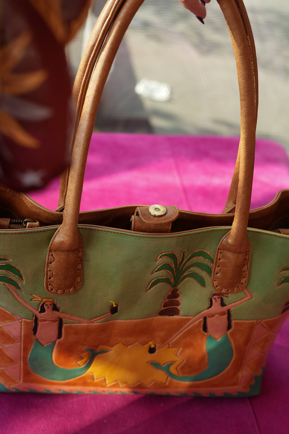 Meet the Desert Siren Tote in Sage and Caramel. A handcrafted leather tote with hand tooled motives artwork, long handles and practical interior compartments.