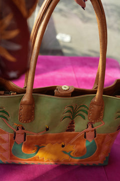 Meet the Desert Siren Tote in Sage and Caramel. A handcrafted leather tote with hand tooled motives artwork, long handles and practical interior compartments.