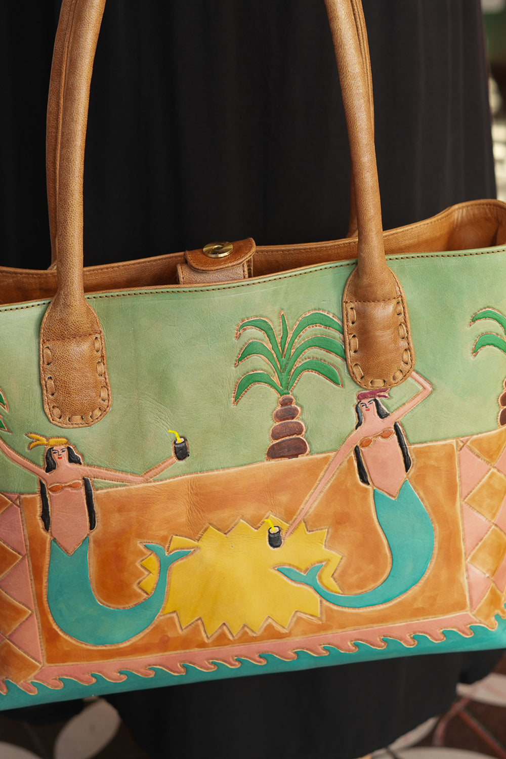 Meet the Desert Siren Tote in Sage and Caramel. A handcrafted leather tote with hand tooled motives artwork, long handles and practical interior compartments.