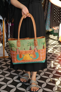 Meet the Desert Siren Tote in Sage and Caramel. A handcrafted leather tote with hand tooled motives artwork, long handles and practical interior compartments.