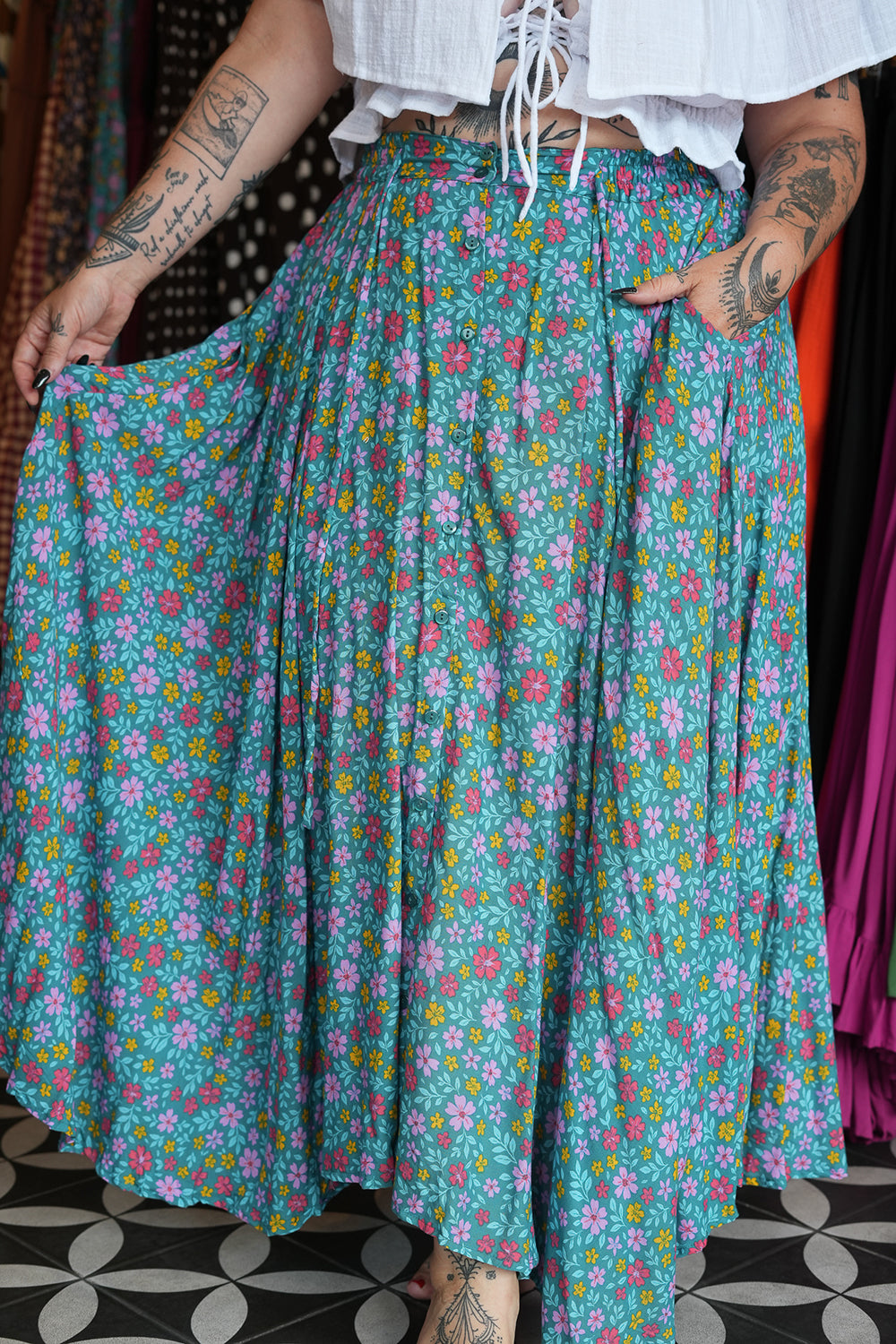 Meet the Fae Skirt in Aqua Bloom, a flowing floral boho maxi with an elastic waist, drawstring, buttons and pockets. Wear it as a skirt or strapless dress.