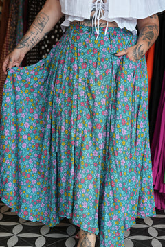 Meet the Fae Skirt in Aqua Bloom, a flowing floral boho maxi with an elastic waist, drawstring, buttons and pockets. Wear it as a skirt or strapless dress.