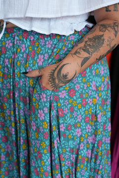 Meet the Fae Skirt in Aqua Bloom, a flowing floral boho maxi with an elastic waist, drawstring, buttons and pockets. Wear it as a skirt or strapless dress.