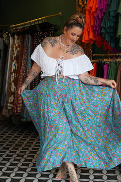 Meet the Fae Skirt in Aqua Bloom, a flowing floral boho maxi with an elastic waist, drawstring, buttons and pockets. Wear it as a skirt or strapless dress.