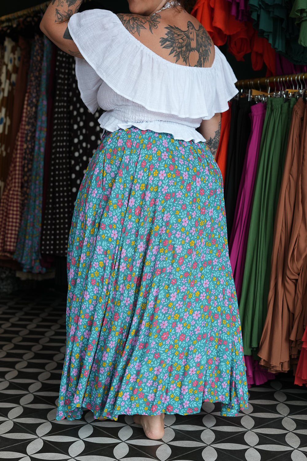 Meet the Fae Skirt in Aqua Bloom, a flowing floral boho maxi with an elastic waist, drawstring, buttons and pockets. Wear it as a skirt or strapless dress.