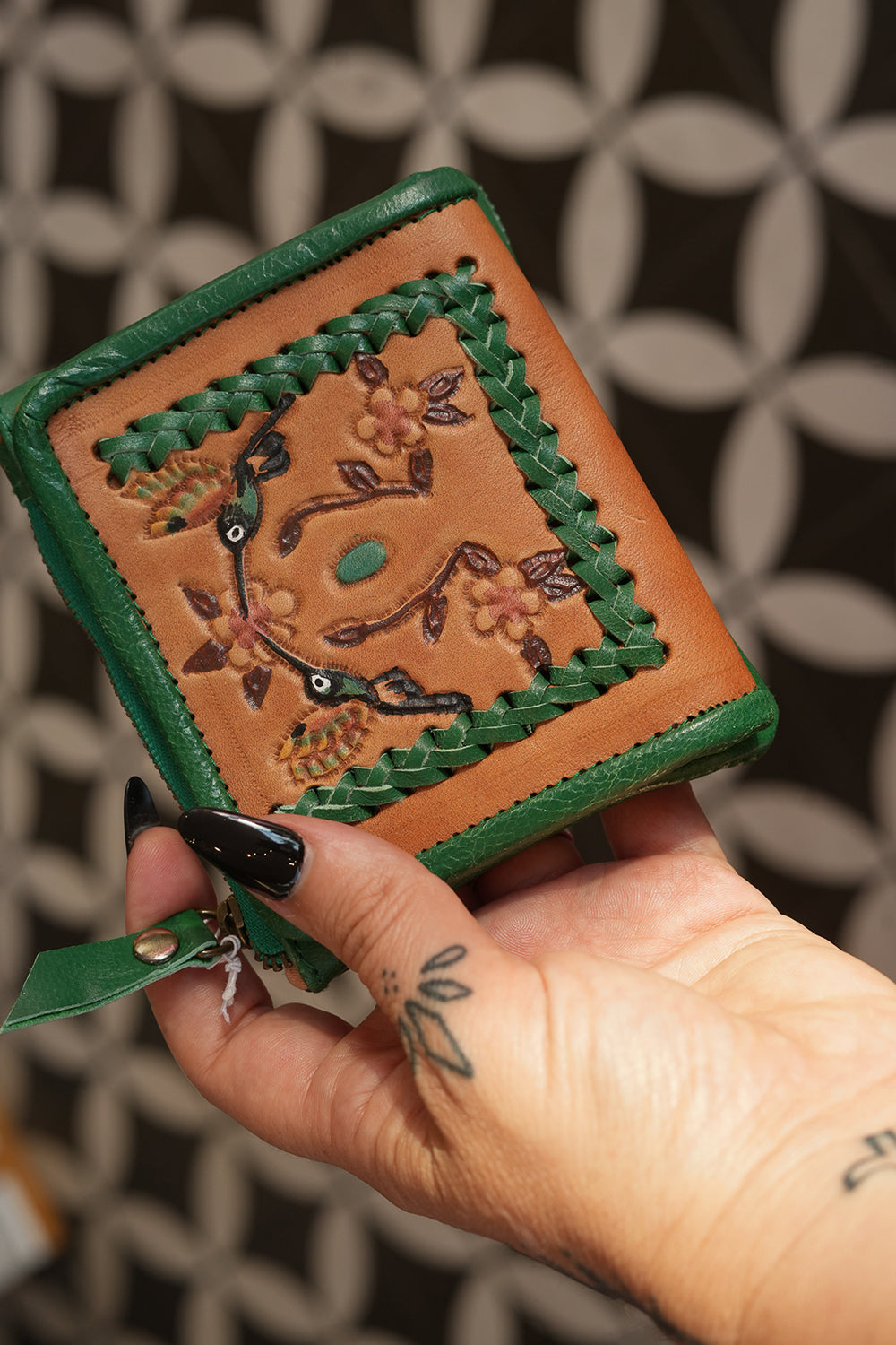 Meet the Freebird Mini Wallet in Cactus Green, a handcrafted leather wallet with hummingbird artwork, woven detailing, turquoise accent and card compartments.