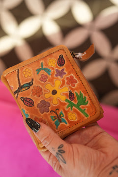 Meet the Freebird Mini Wallet in Desert Honey, a handcrafted leather wallet with colorful flowers, hummingbirds, ladybirds and butterfly artwork.