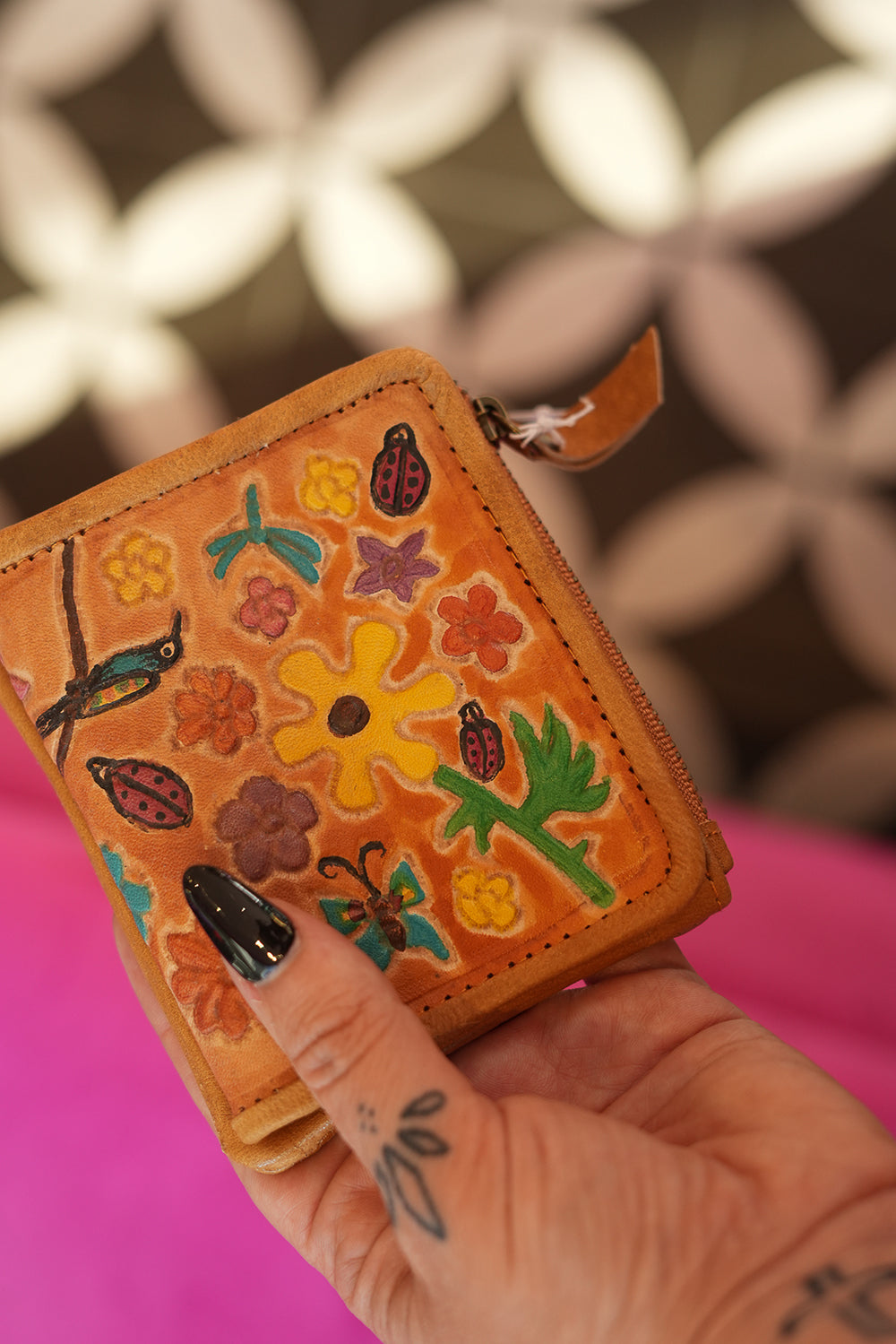Meet the Freebird Mini Wallet in Desert Honey, a handcrafted leather wallet with colorful flowers, hummingbirds, ladybirds and butterfly artwork.