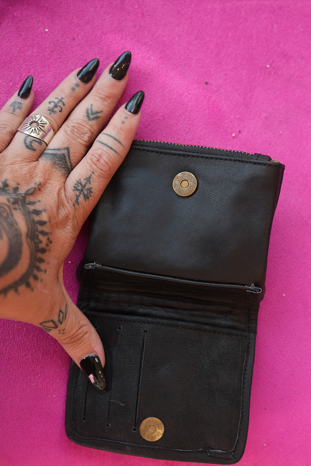 Meet the Freebird Mini Wallet in Midnight Black, a handcrafted leather wallet with colorful hummingbird artwork, turquoise accent and woven leather detailing.