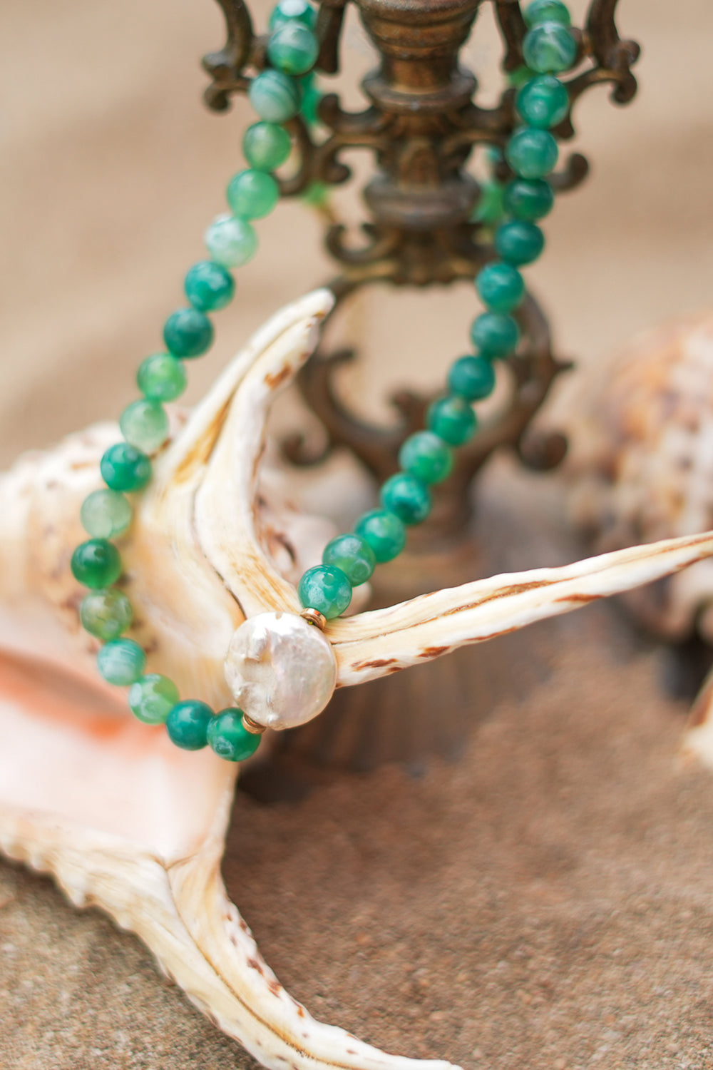 Shop the Gaia Pearl Necklace in Forest Agate, featuring green natural stone beads, an organic statement pearl and delicate gold toned details by Jinx the Label.