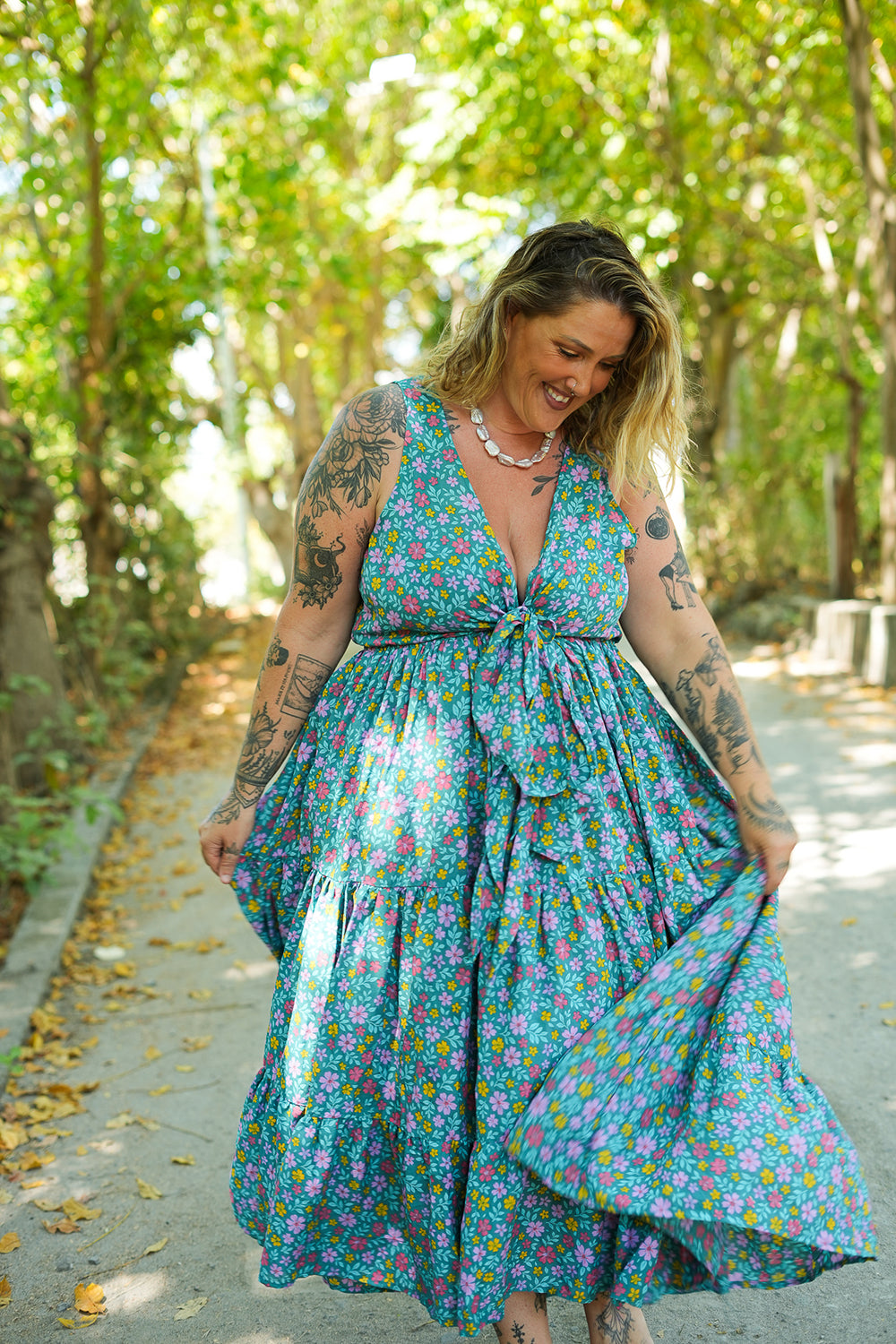 Meet the Jessie Maxi Dress in Aqua Bloom, a dreamy floral maxi with a tie front bodice, plunging neckline, flowing tiered skirt and pockets. Handmade in Bali.