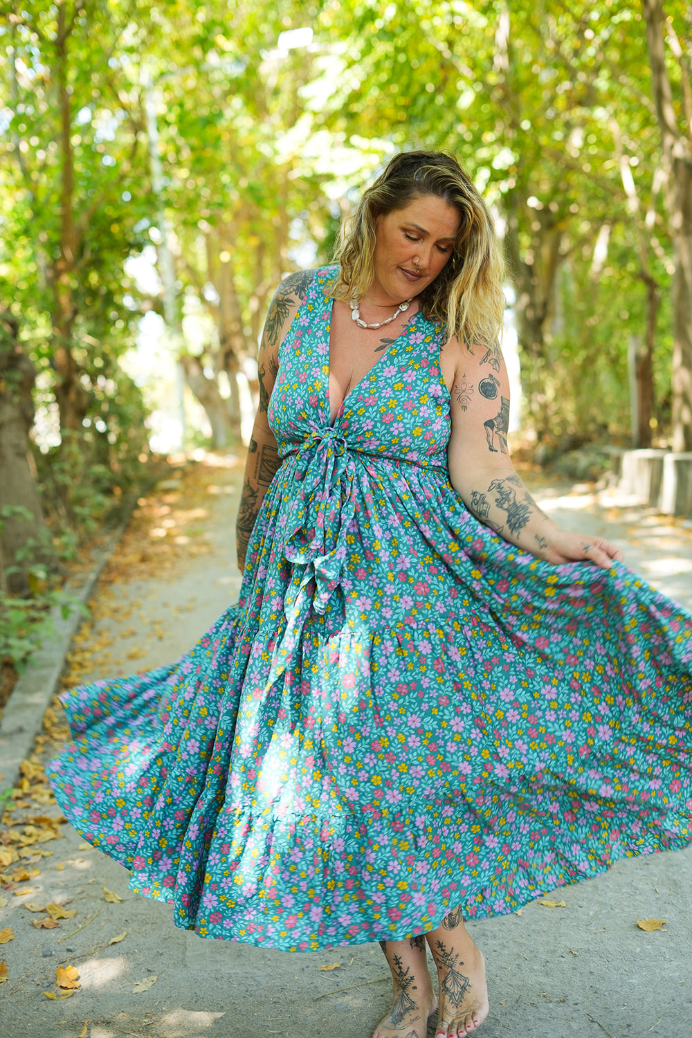 Meet the Jessie Maxi Dress in Aqua Bloom, a dreamy floral maxi with a tie front bodice, plunging neckline, flowing tiered skirt and pockets. Handmade in Bali.