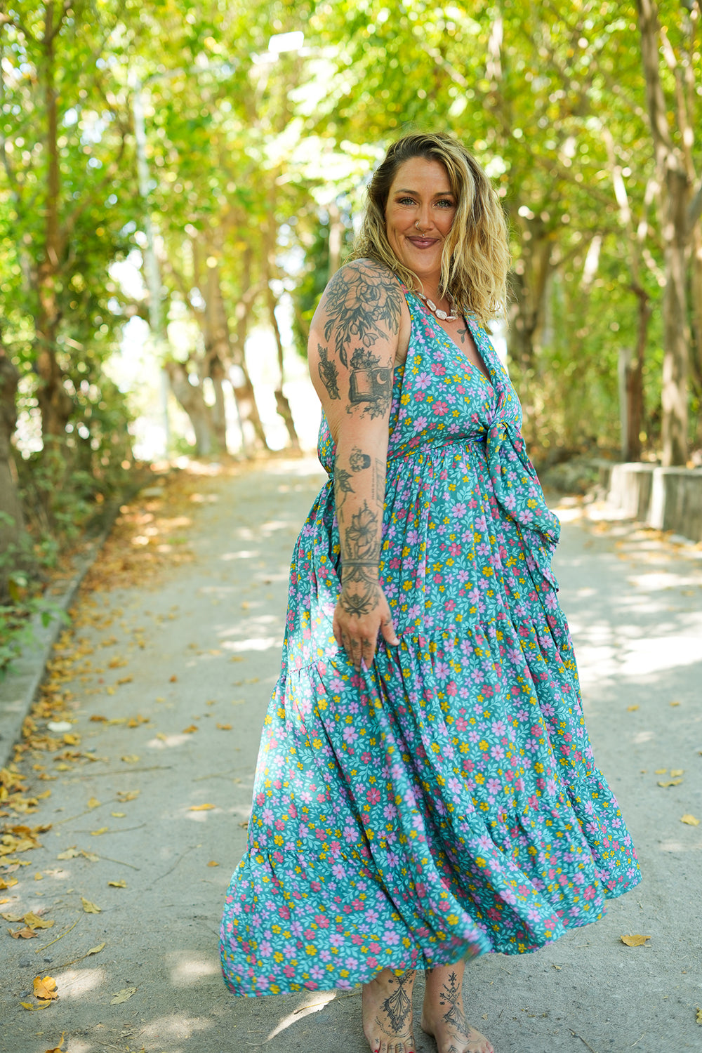 Meet the Jessie Maxi Dress in Aqua Bloom, a dreamy floral maxi with a tie front bodice, plunging neckline, flowing tiered skirt and pockets. Handmade in Bali.