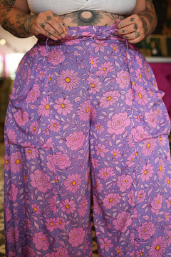 Meet the Kirana Pants in Sugarbloom. Floaty rayon wide leg pants in our dreamy purple and pink floral print, with an elastic waist, drawstring and pockets.