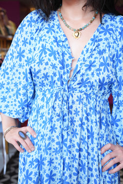 Meet the Magnolia Dress in Floral Blue, a flowing floral boho maxi with billowy sleeves, shell buttons, adjustable waist tie and pockets. Handmade in Bali.
