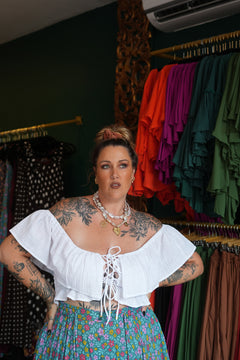 Maria Top in soft White Cotton with an off-shoulder ruffle neckline, adjustable lace up front and shirred waist. Handmade in Bali by Jinx the Label.