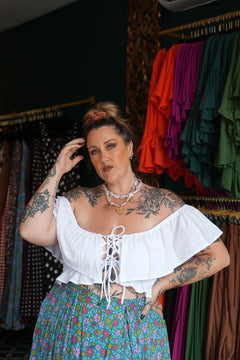 Maria Top in soft White Cotton with an off-shoulder ruffle neckline, adjustable lace up front and shirred waist. Handmade in Bali by Jinx the Label.