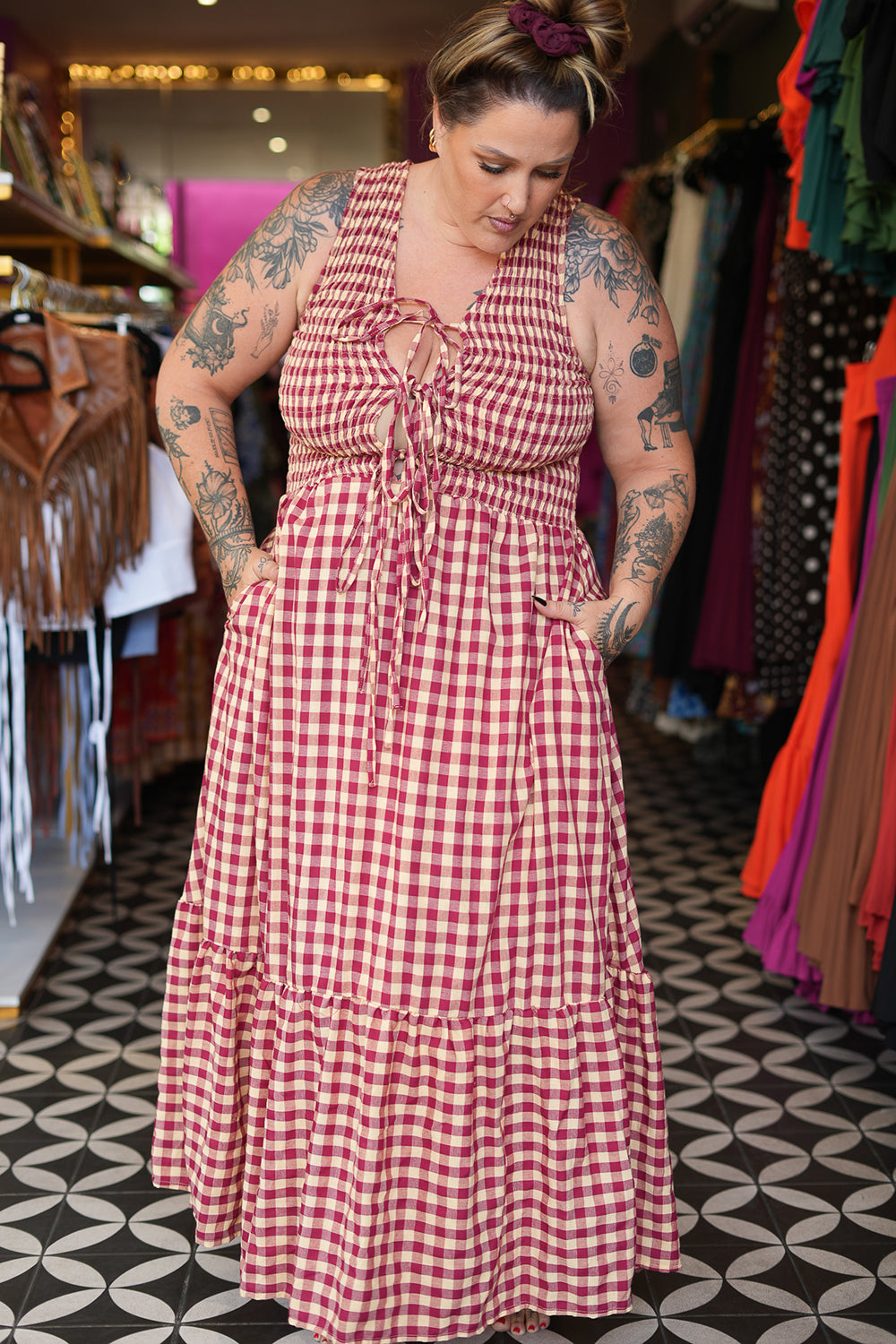 Meet the Mayana Maxi Dress in Wine Cream from Nevada. A dreamy rayon gingham maxi with shirring, adjustable front ties, a flowing ruffled skirt and pockets.