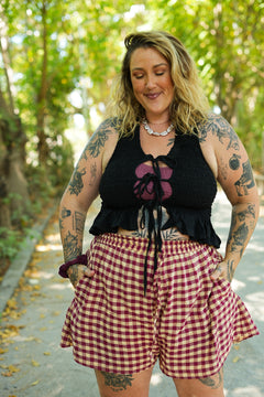Meet the Mayana Top in Black, a shirred rayon halter with front ties and a flirty ruffle hem. Stretchy, curve loving and handmade in Bali.