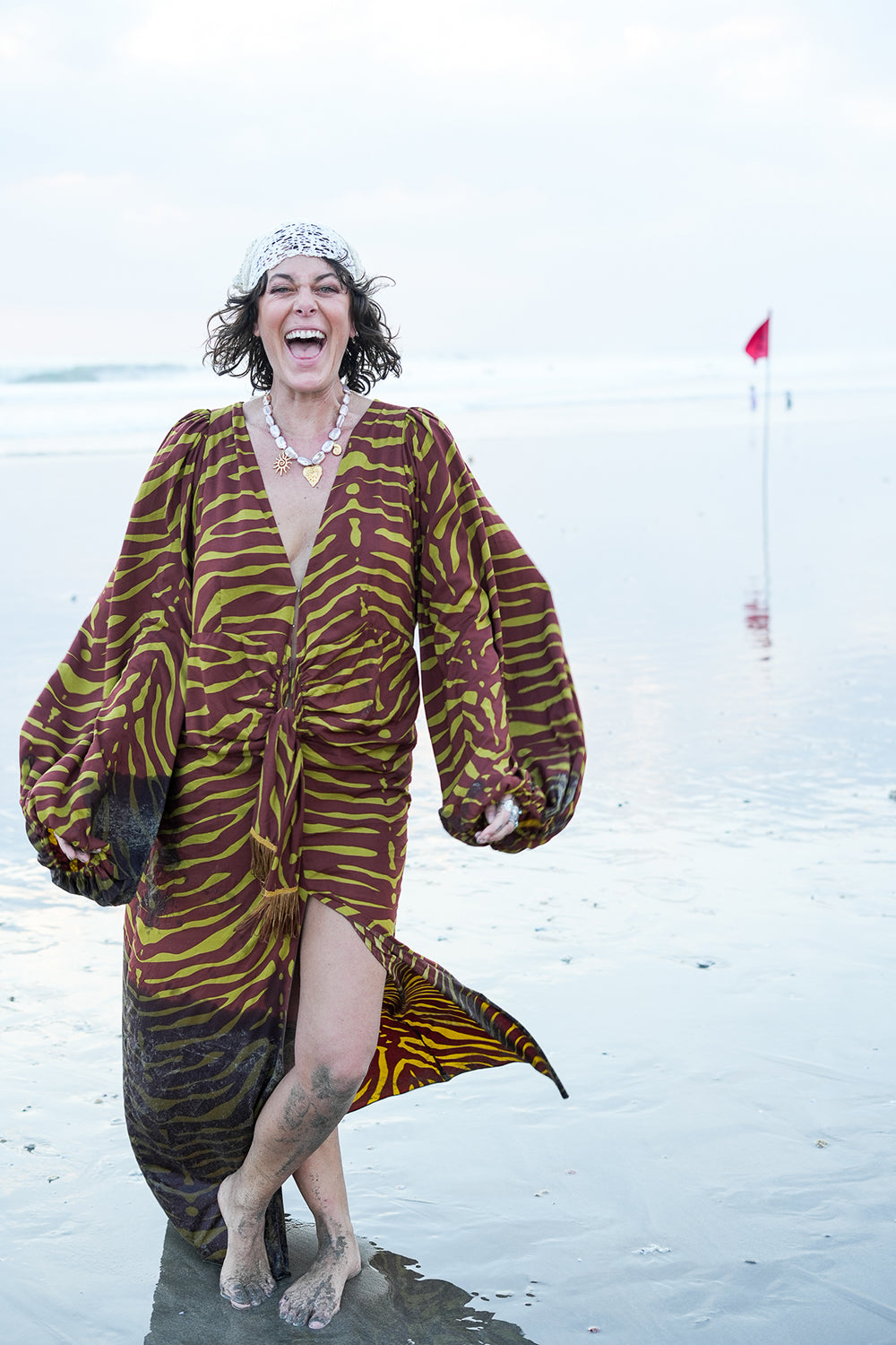 Meet the Melissa Dress in Zebra Yellow. A flowing rayon maxi with dramatic long sleeves, deep V-neck, gathered waist and tassel detail. Handmade in Bali.