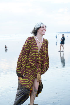 Meet the Melissa Dress in Zebra Yellow. A flowing rayon maxi with dramatic long sleeves, deep V-neck, gathered waist and tassel detail. Handmade in Bali.