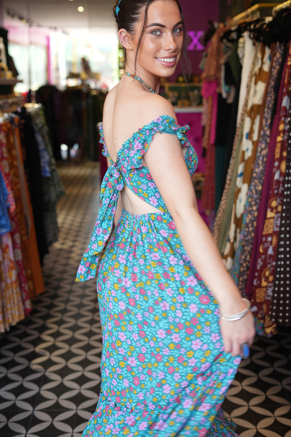 Meet the Mina Maxi Dress in Aqua Moon. A romantic rayon maxi with shirred bodice, off-shoulder ruffles, open tie back, pockets and flowing tiers.