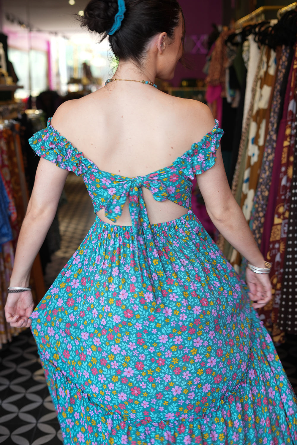 Meet the Mina Maxi Dress in Aqua Moon. A romantic rayon maxi with shirred bodice, off-shoulder ruffles, open tie back, pockets and flowing tiers.