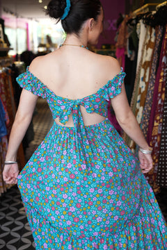 Meet the Mina Maxi Dress in Aqua Moon. A romantic rayon maxi with shirred bodice, off-shoulder ruffles, open tie back, pockets and flowing tiers.