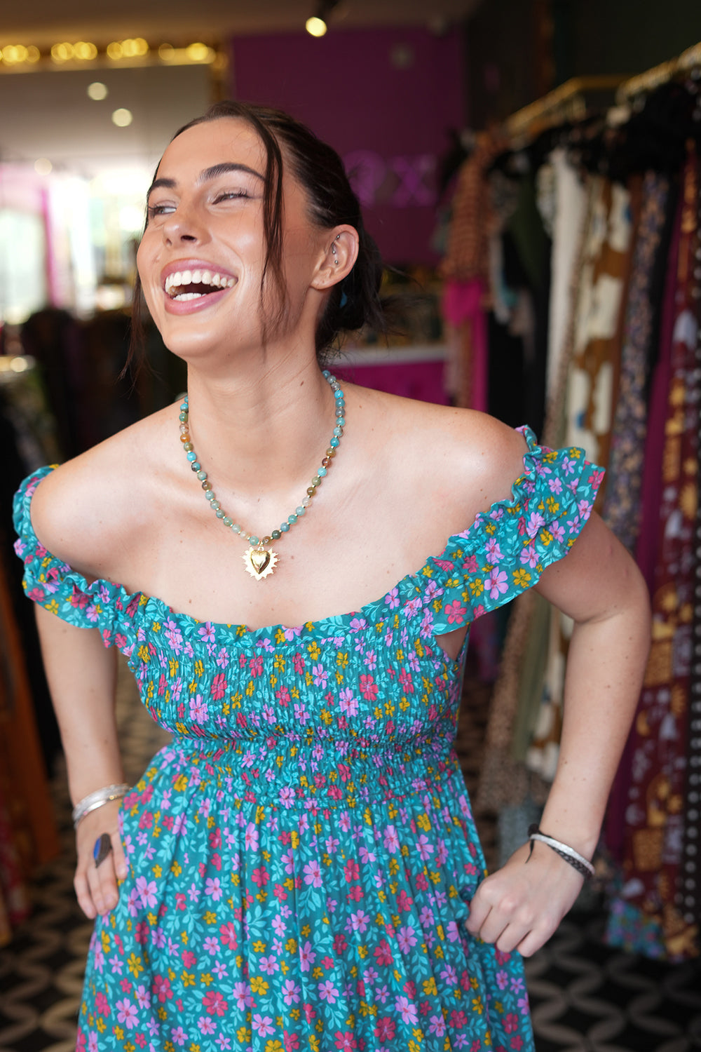 Meet the Mina Maxi Dress in Aqua Moon. A romantic rayon maxi with shirred bodice, off-shoulder ruffles, open tie back, pockets and flowing tiers.