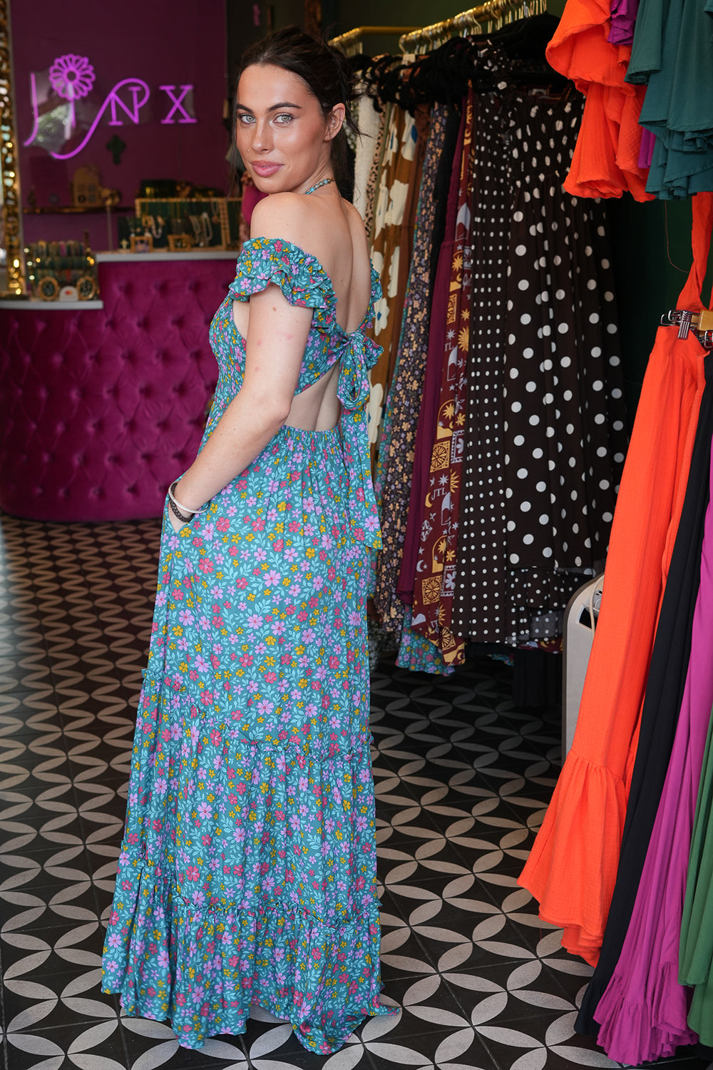 Meet the Mina Maxi Dress in Aqua Moon. A romantic rayon maxi with shirred bodice, off-shoulder ruffles, open tie back, pockets and flowing tiers.