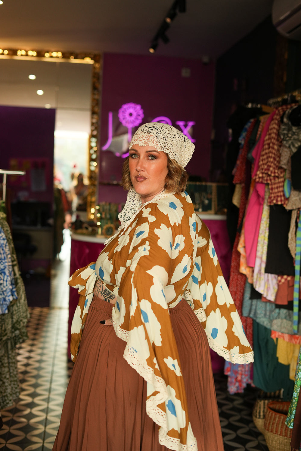 Meet the Miranda Wrap Top in Wildflower. A bohemian wrap top with dramatic wide sleeves, crochet trim and our bold floral print. Handmade in Bali.