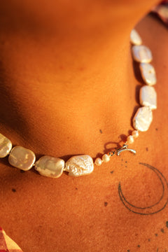 Discover the Moon Tide Necklace in Lunar Pearl, with irregular natural pearls and a gold toned toggle closure from Earth Altering by Jinx the Label.