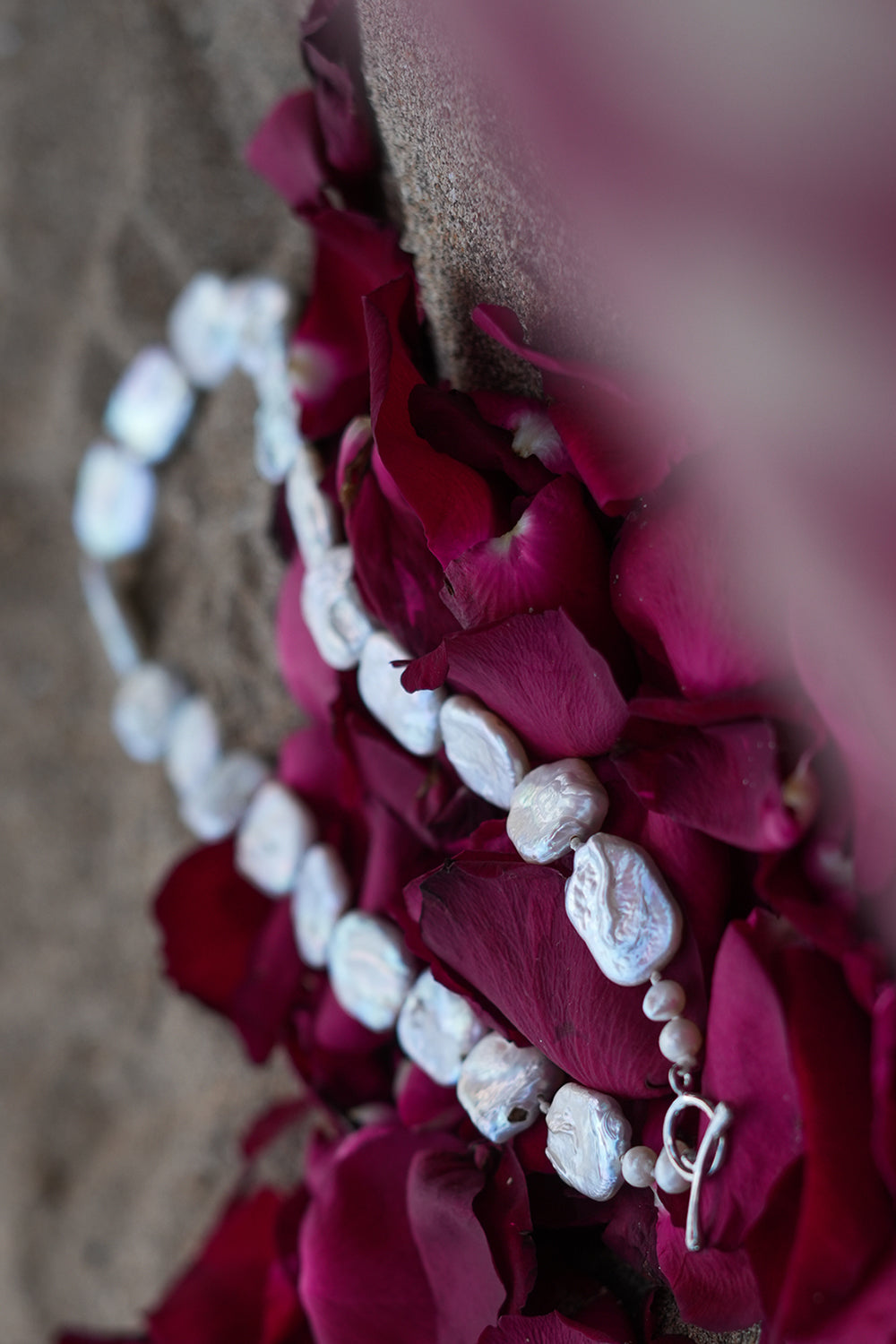 Discover the Moon Tide Necklace in Lunar Pearl, with irregular natural pearls and a gold toned toggle closure from Earth Altering by Jinx the Label.